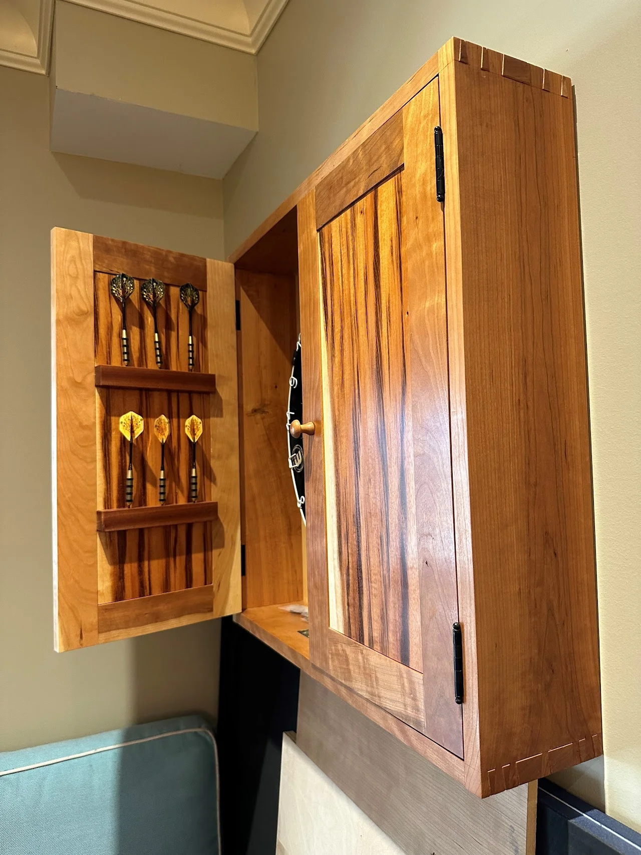 Dartboard cabinet with decorative doors